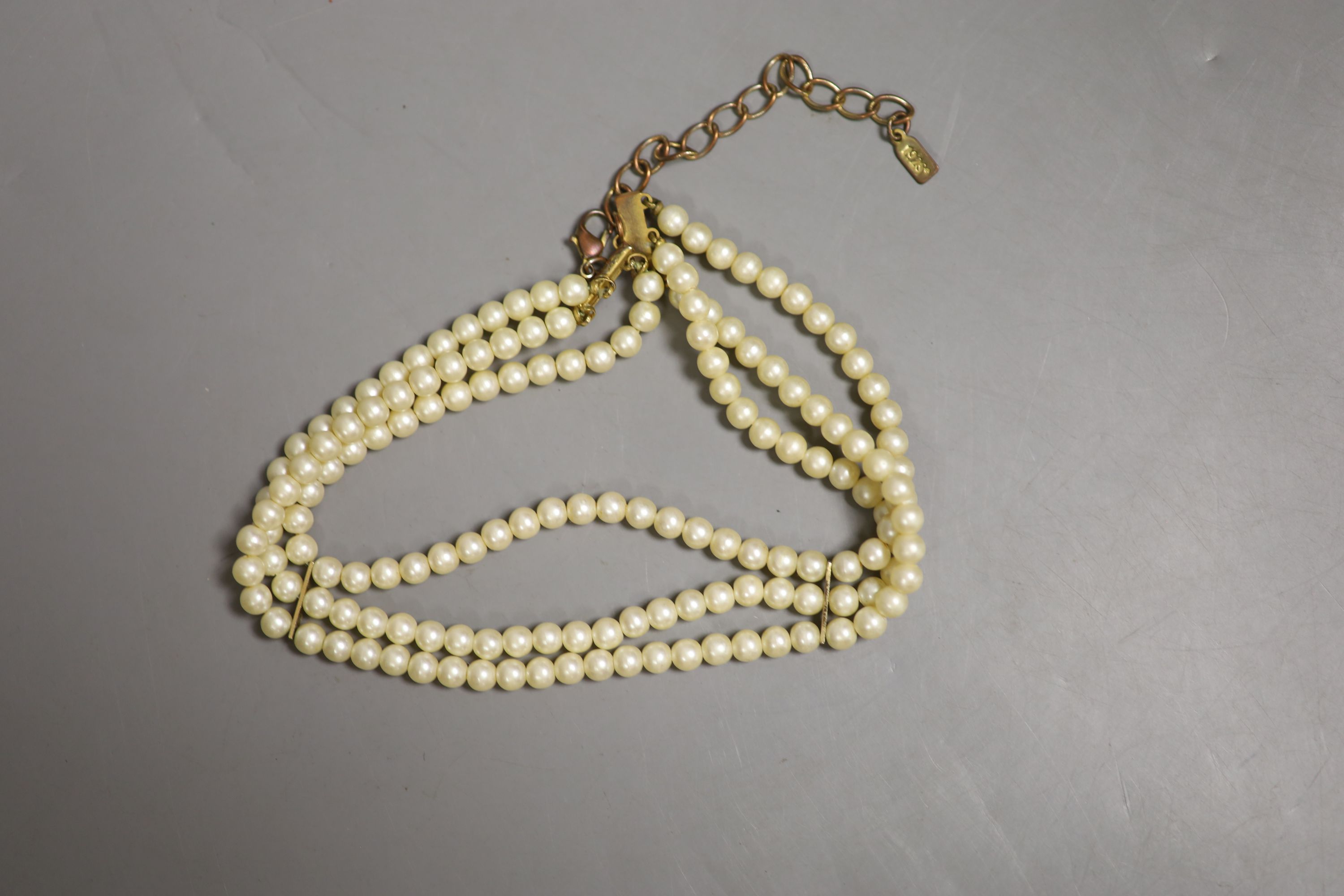 A triple strand cultured pearl choker necklace and four other items.